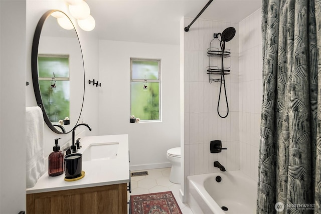 bathroom featuring tile patterned floors, baseboards, vanity, toilet, and shower / bath combo with shower curtain