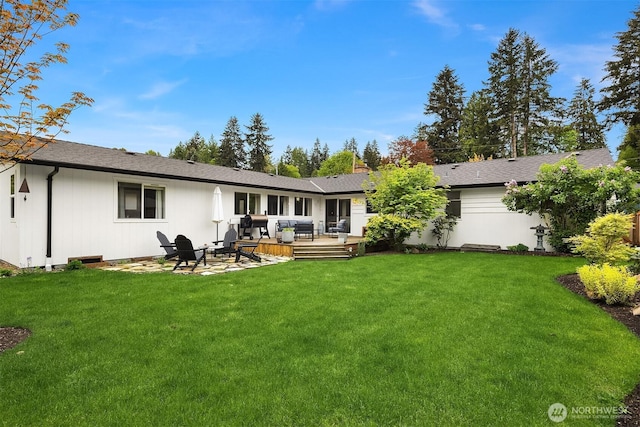 back of house with a yard, a deck, and an outdoor hangout area