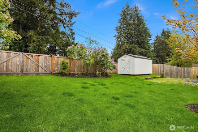 view of yard featuring a storage shed, an outbuilding, and a fenced backyard