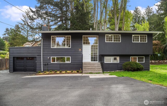 split foyer home with a garage and a chimney