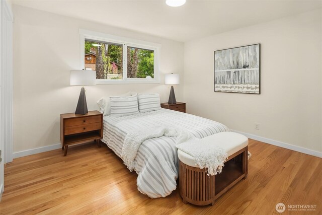 bedroom featuring baseboards and light wood-style flooring