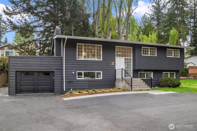 8004 203rd Pl SW, Edmonds, WA 98026 - raised ranch with an attached garage, driveway, and a chimney