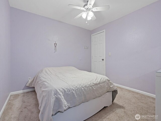 bedroom with carpet floors, a ceiling fan, and baseboards