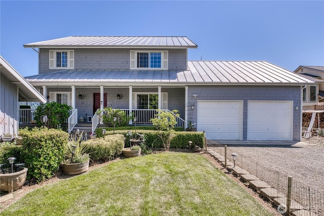 135 NE Boad Haven Rd, Belfair, WA 98528 - view of front of property with a standing seam roof, an attached garage, metal roof, and a front lawn