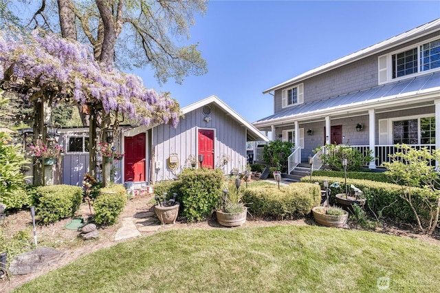 135 NE Boad Haven Rd, Belfair, WA 98528 - view of front of property featuring a front lawn, covered porch, and metal roof