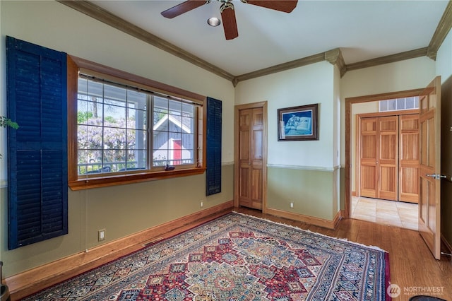 135 NE Boad Haven Rd, Belfair, WA 98528 - empty room featuring ornamental molding, wood finished floors, a ceiling fan, and baseboards