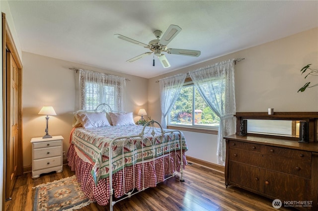 135 NE Boad Haven Rd, Belfair, WA 98528 - bedroom with multiple windows, wood finished floors, and baseboards