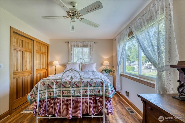 135 NE Boad Haven Rd, Belfair, WA 98528 - bedroom featuring multiple windows, wood finished floors, and baseboards