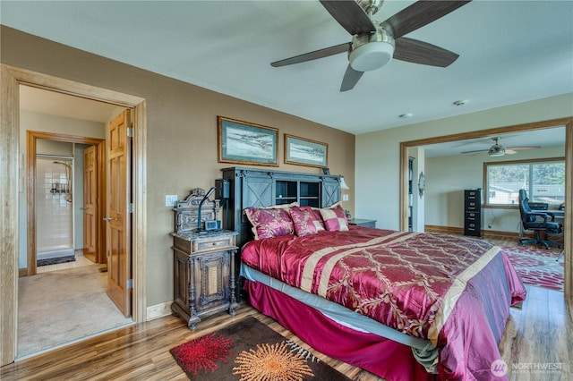 135 NE Boad Haven Rd, Belfair, WA 98528 - bedroom with wood finished floors, baseboards, and a ceiling fan