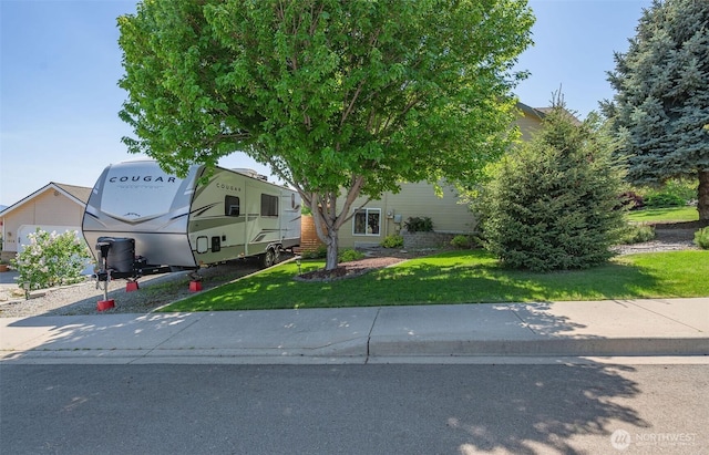 obstructed view of property featuring a front lawn