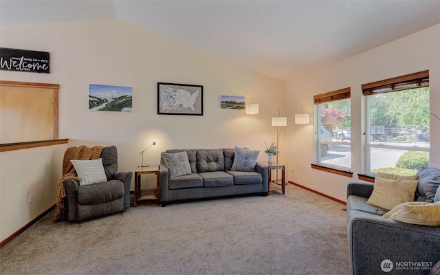 living room with carpet flooring, vaulted ceiling, and baseboards