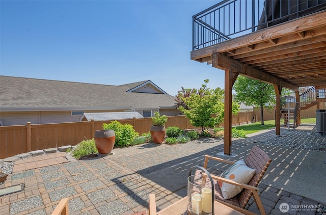 view of patio / terrace with central AC, a deck, stairway, and a fenced backyard