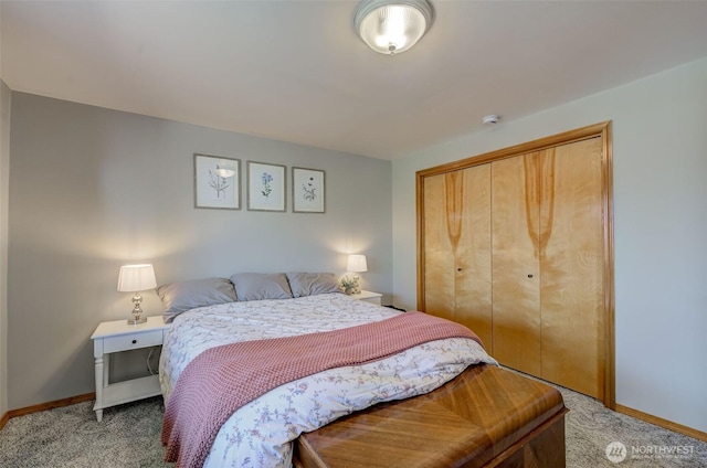bedroom featuring light colored carpet, a closet, and baseboards