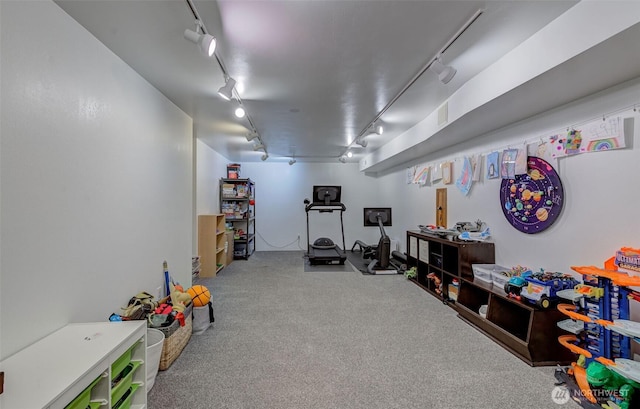 recreation room featuring carpet and track lighting