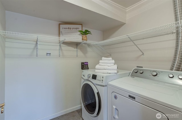 laundry room with ornamental molding, separate washer and dryer, laundry area, and baseboards