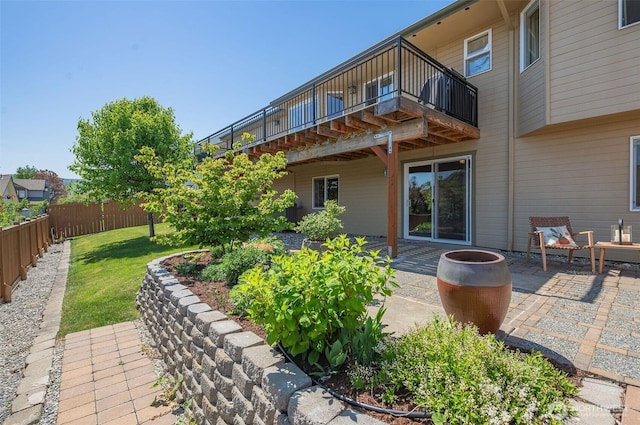 rear view of property with a lawn, a patio area, and fence