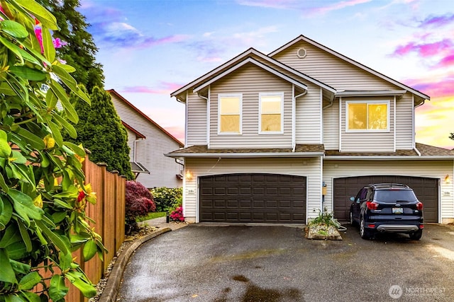 view of front of house with a garage and asphalt driveway