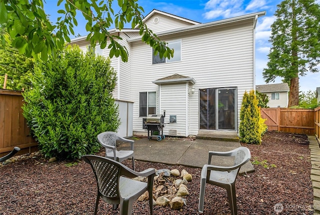 back of house featuring a patio and a fenced backyard