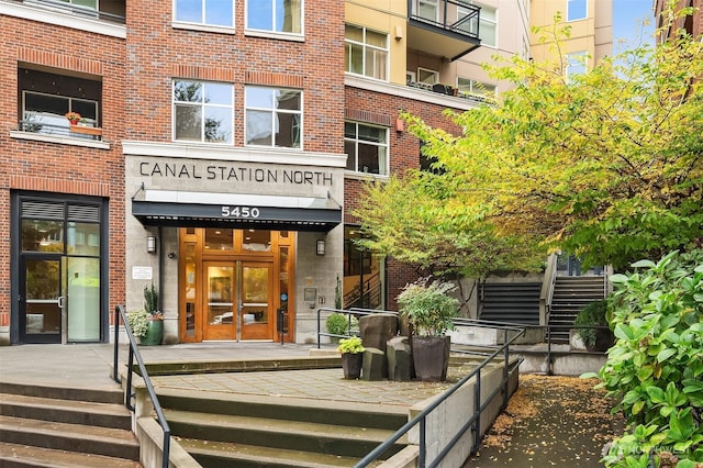 entrance to property featuring french doors and brick siding