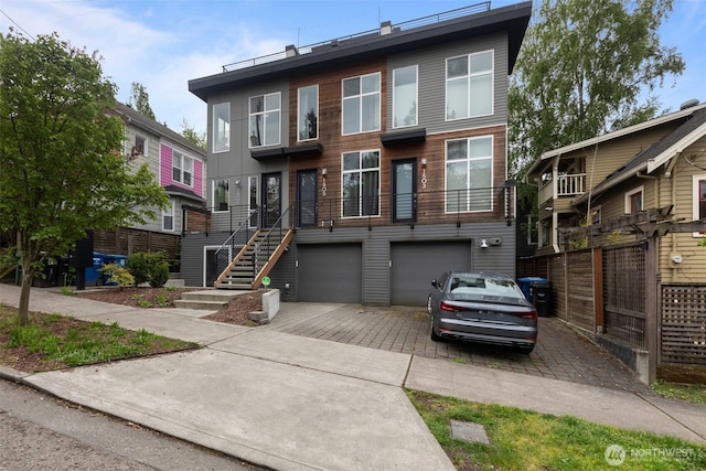 view of property featuring a garage and decorative driveway