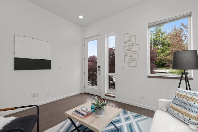 living room featuring baseboards, recessed lighting, and wood finished floors