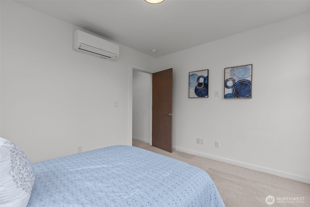bedroom with baseboards, a wall unit AC, and light carpet