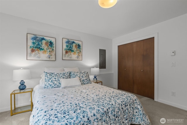 bedroom with baseboards, light carpet, and a closet