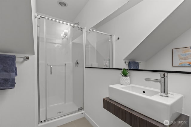 bathroom with a sink and a stall shower