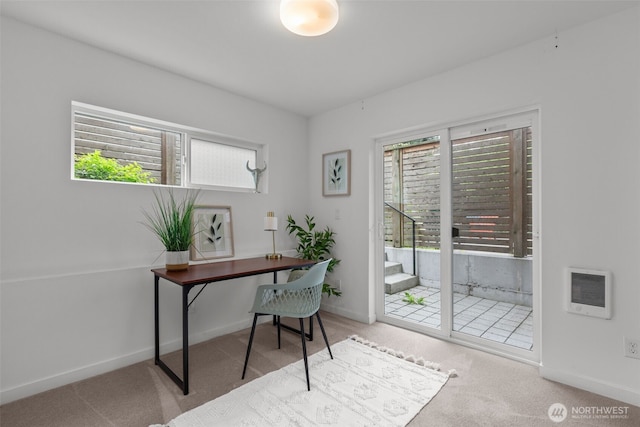 office area with heating unit, carpet floors, and baseboards