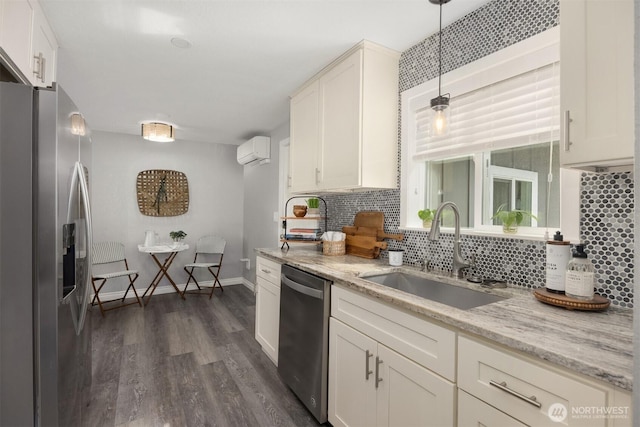 kitchen featuring appliances with stainless steel finishes, a sink, backsplash, dark wood-style flooring, and a wall mounted AC