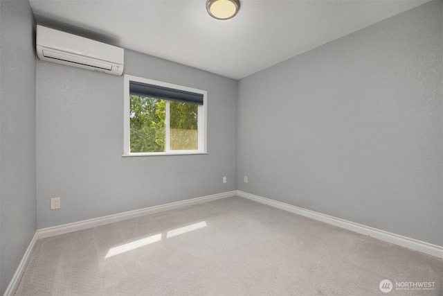 empty room with a wall mounted air conditioner, carpet flooring, and baseboards