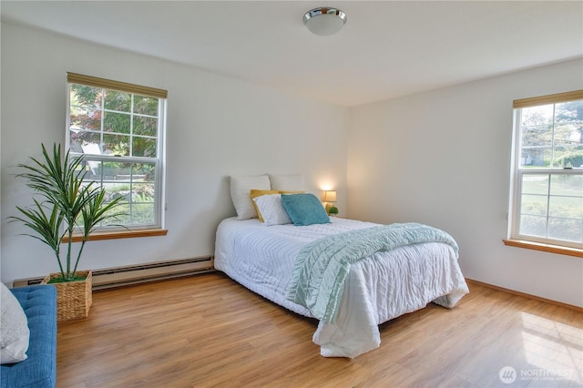 500 Creekside Ter Unit 101, Langley, WA 98260 - bedroom with a baseboard heating unit and wood finished floors