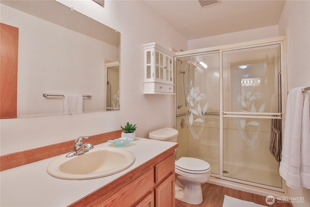 500 Creekside Ter Unit 101, Langley, WA 98260 - full bath featuring a stall shower, toilet, vanity, and wood finished floors