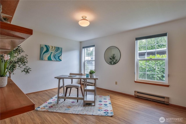 500 Creekside Ter Unit 101, Langley, WA 98260 - dining room with a baseboard radiator, baseboard heating, light wood-style flooring, and baseboards