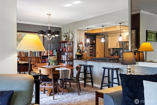 dining area featuring an inviting chandelier and ornamental molding