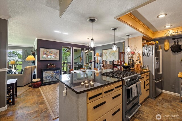 kitchen with crown molding, a textured ceiling, appliances with stainless steel finishes, and stone finish floor