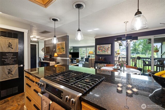 kitchen featuring ornamental molding, a textured ceiling, and gas range