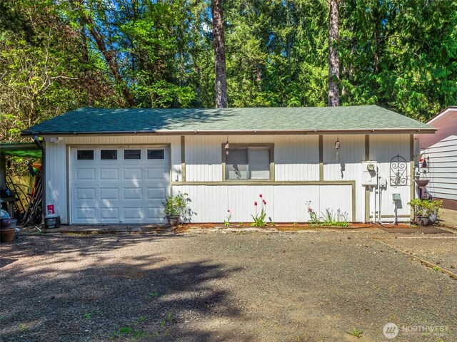 garage with gravel driveway