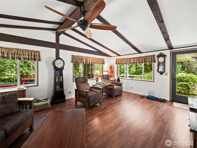 living room featuring a ceiling fan, baseboards, a healthy amount of sunlight, and vaulted ceiling with beams