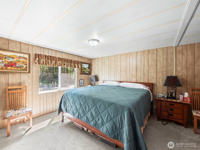 carpeted bedroom with wood walls