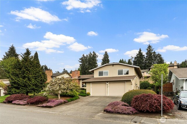 tri-level home with a garage and driveway