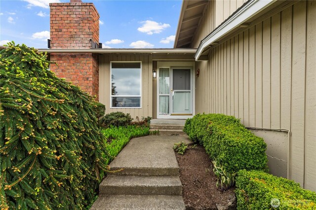 doorway to property with a chimney
