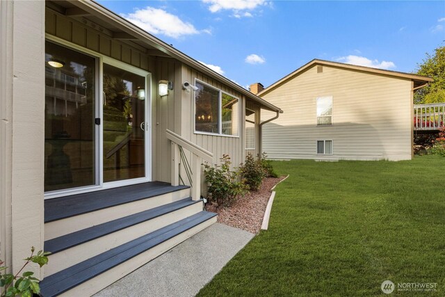 exterior space featuring a yard and board and batten siding