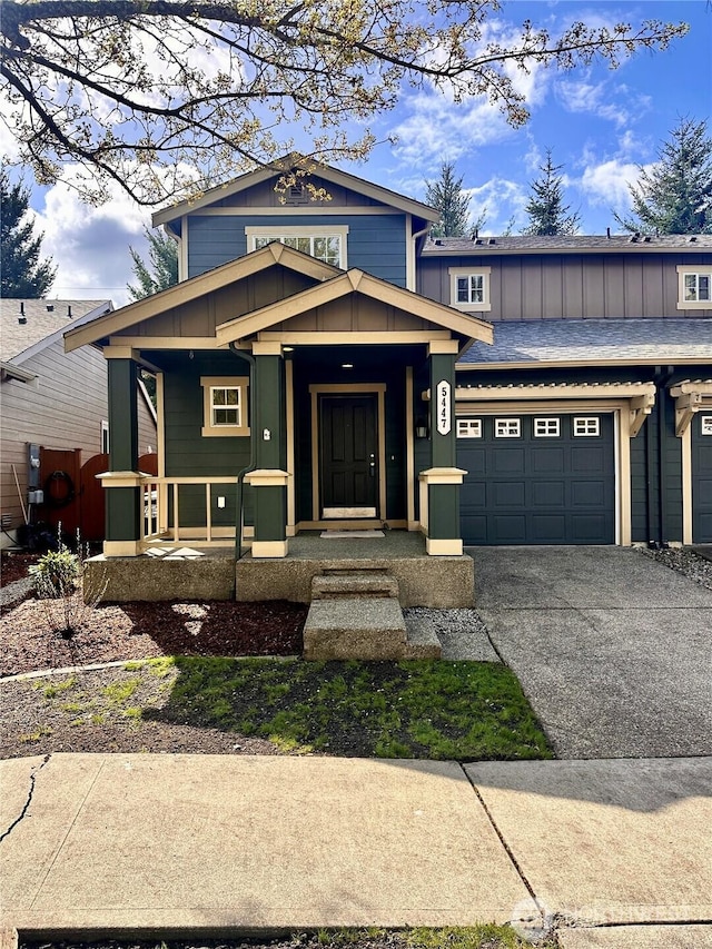 view of front of property with an attached garage, board and batten siding, covered porch, and driveway