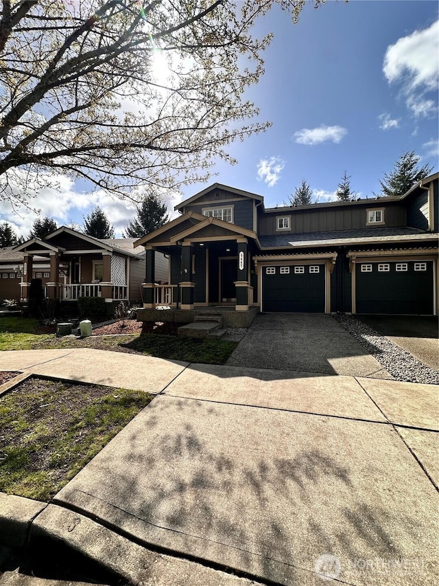 view of front of home featuring a garage, covered porch, and driveway