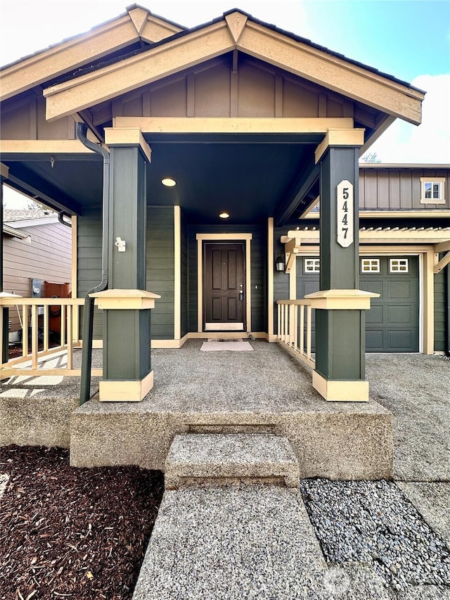 view of exterior entry featuring board and batten siding and a porch