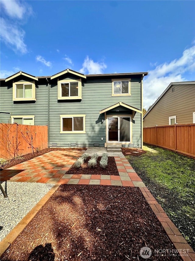 view of front of home featuring a patio and a fenced backyard