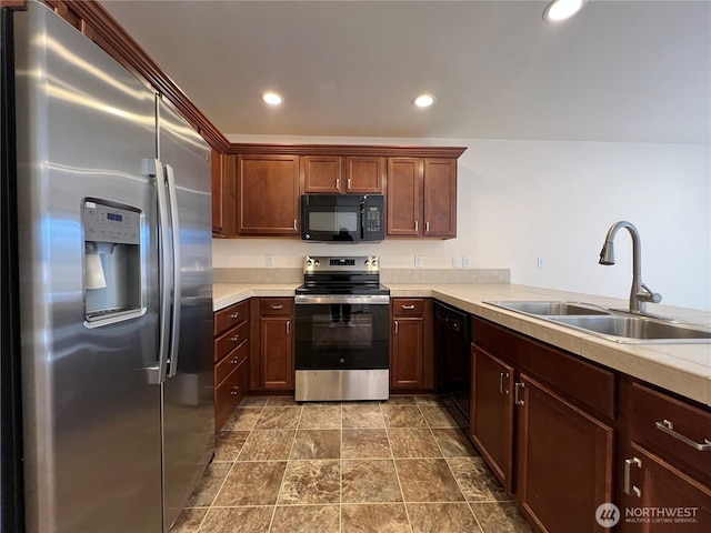 kitchen featuring a sink, black appliances, and light countertops