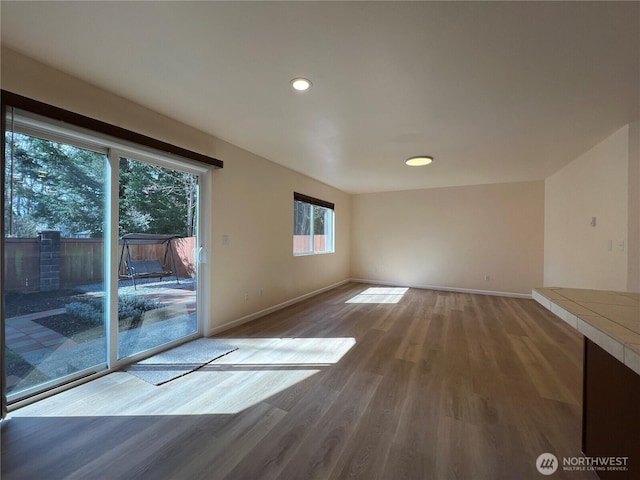 interior space with recessed lighting, baseboards, and wood finished floors
