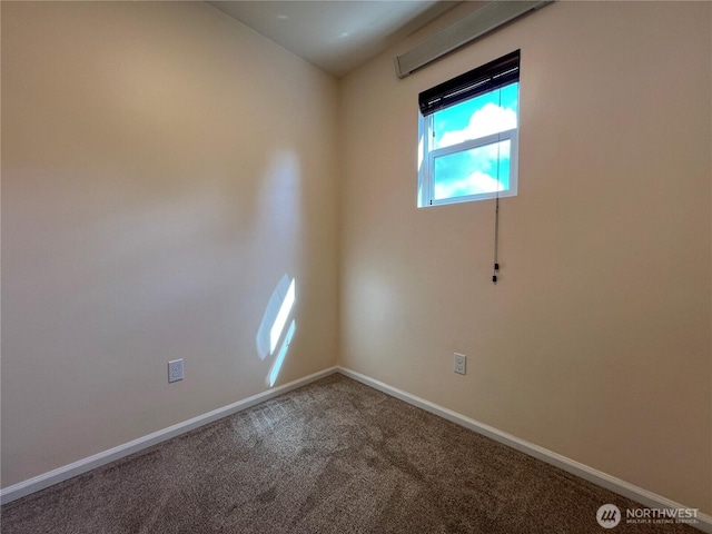 spare room with baseboards and carpet flooring